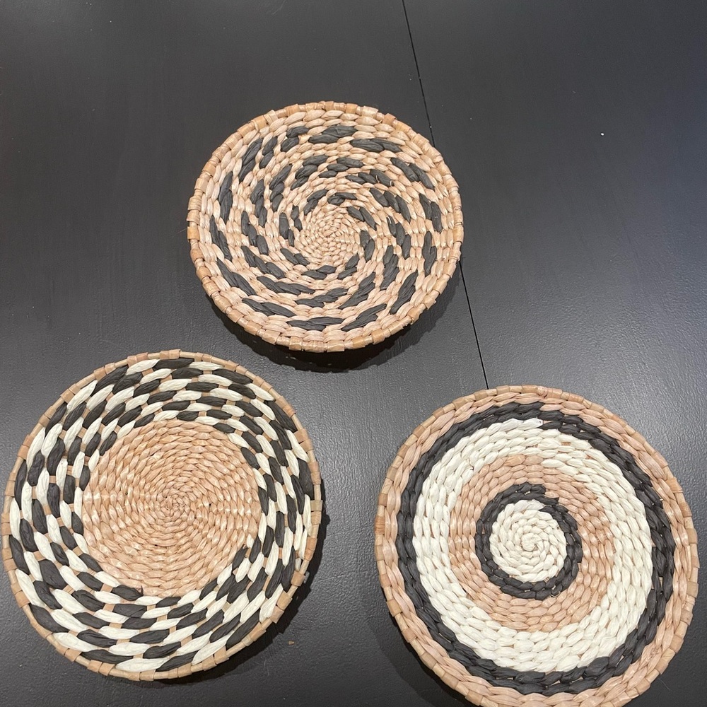 Set of 3 round boho wicker basket wall hangings.